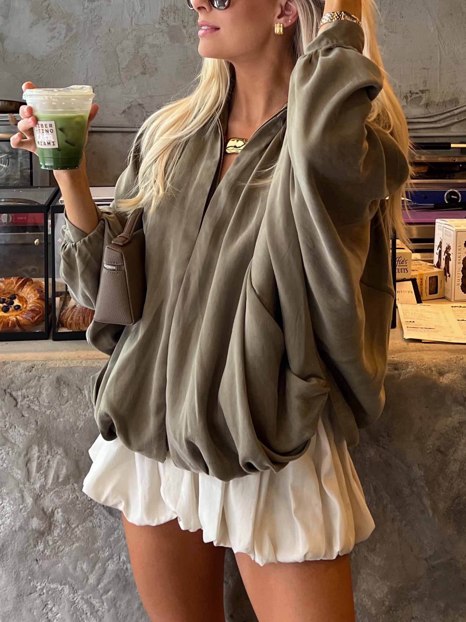 Cream satin high-waist bubble-hem mini shorts with layered ruffle hem, side view