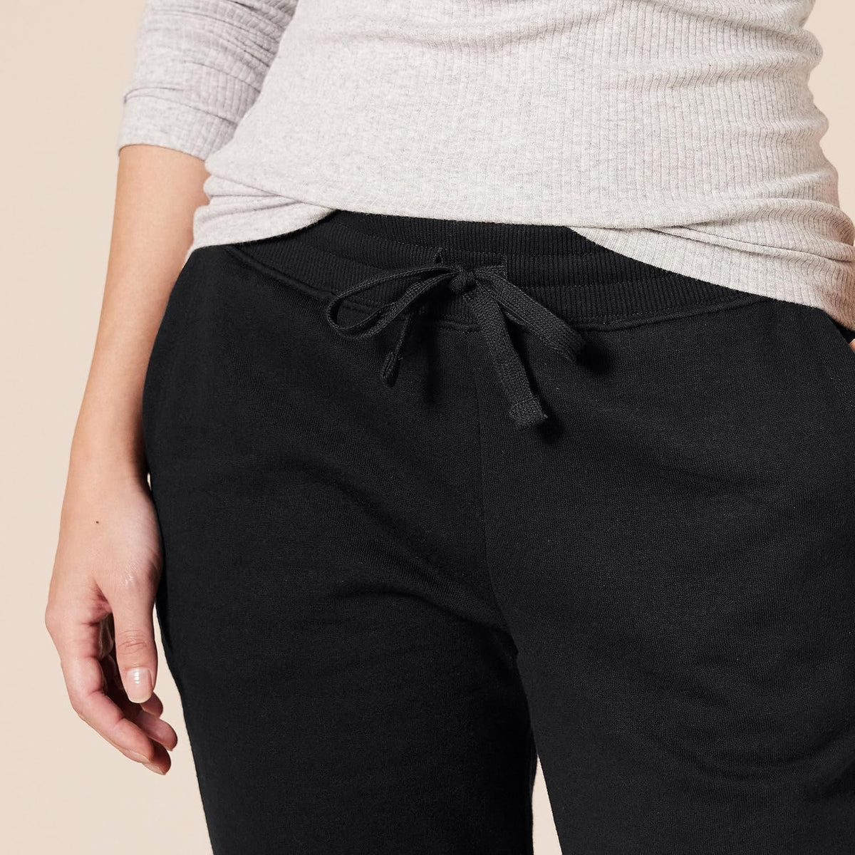 Women’s black fleece sweatpants with drawstring waistband and side pockets.