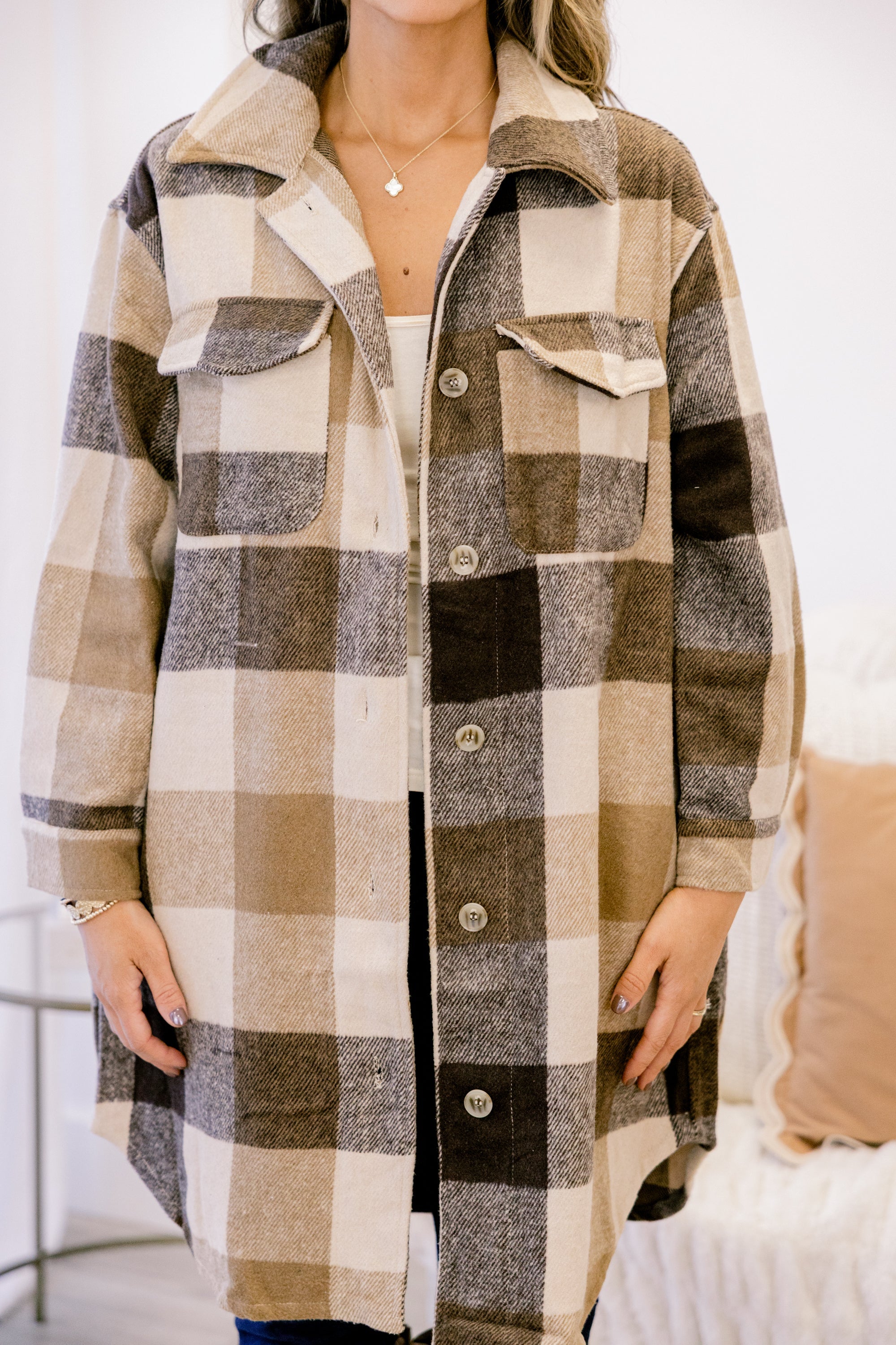 Camel plaid coat front with spread collar, button placket, and two flap chest pockets