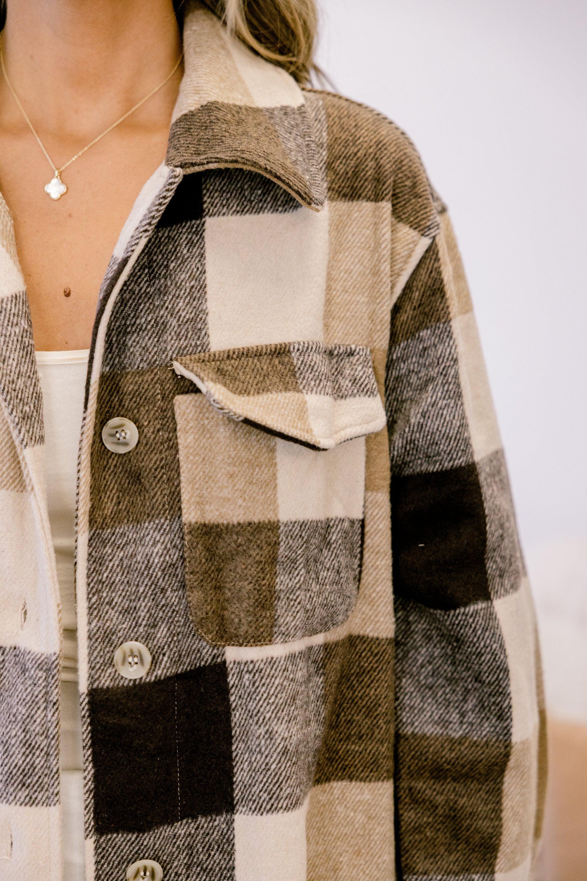 Camel plaid coat chest pocket with button and flap detail