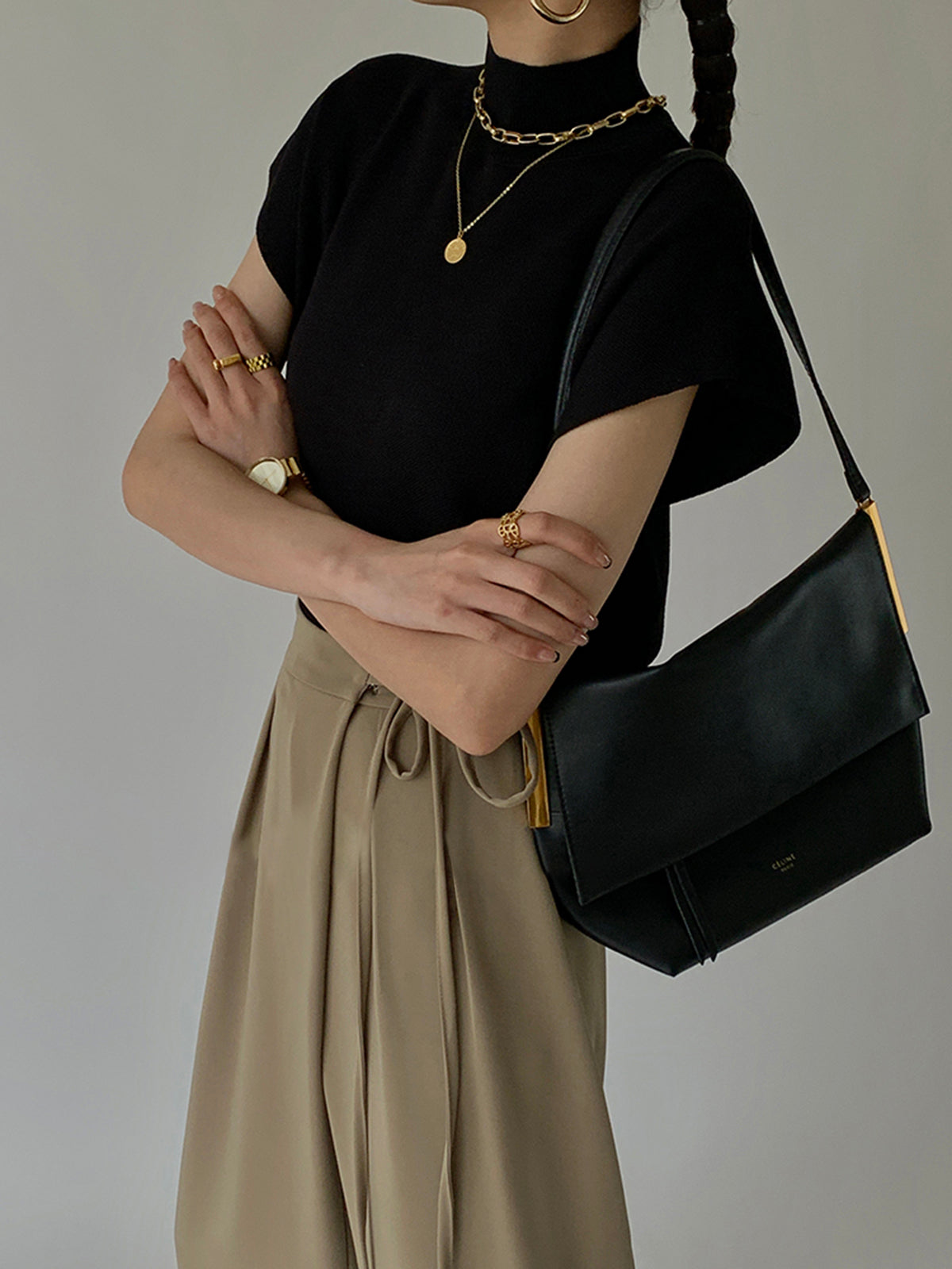 Black sleeveless mock neck knit top, draped fit with short sleeves