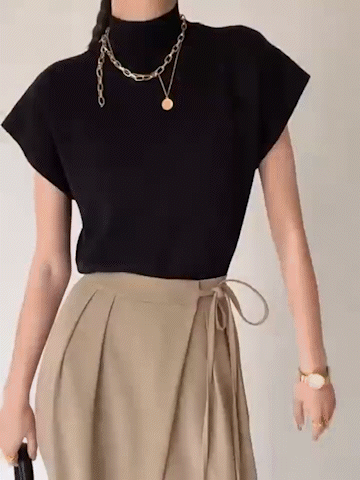 Black sleeveless mock neck knit top with layered chain necklace neckline