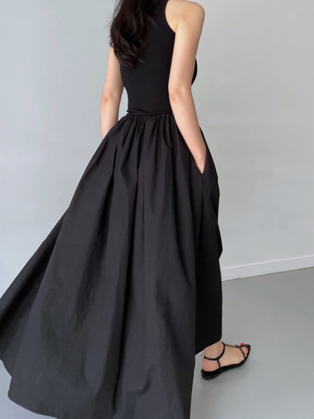 Black cotton sleeveless midi dress, back view, ribbed bodice with gathered skirt