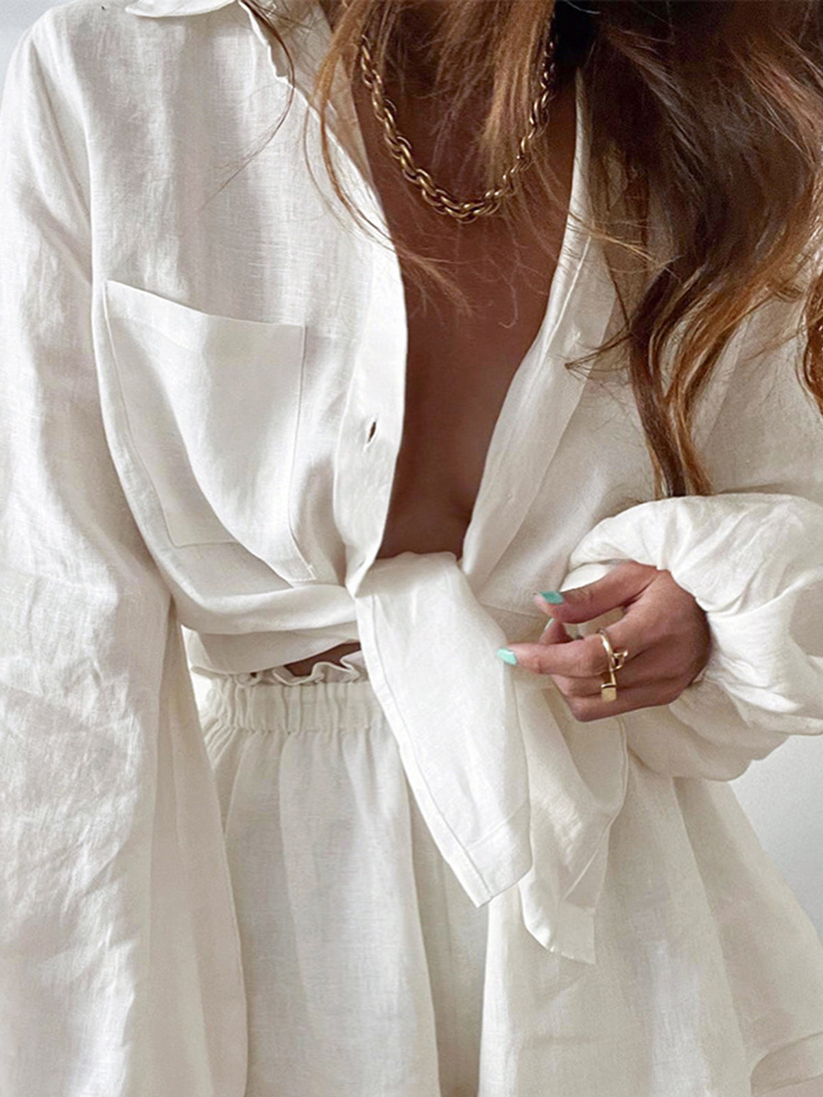 White linen button-up shirt with chest pocket and matching elastic waist ruffled shorts