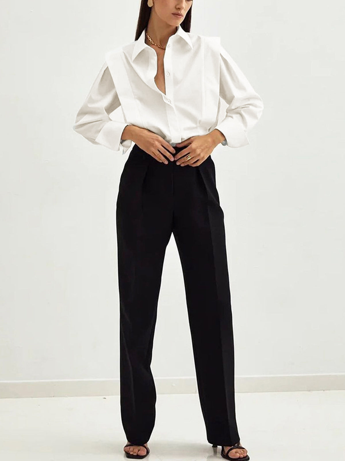 White cotton oversized button-down blouse with pointed collar and button front