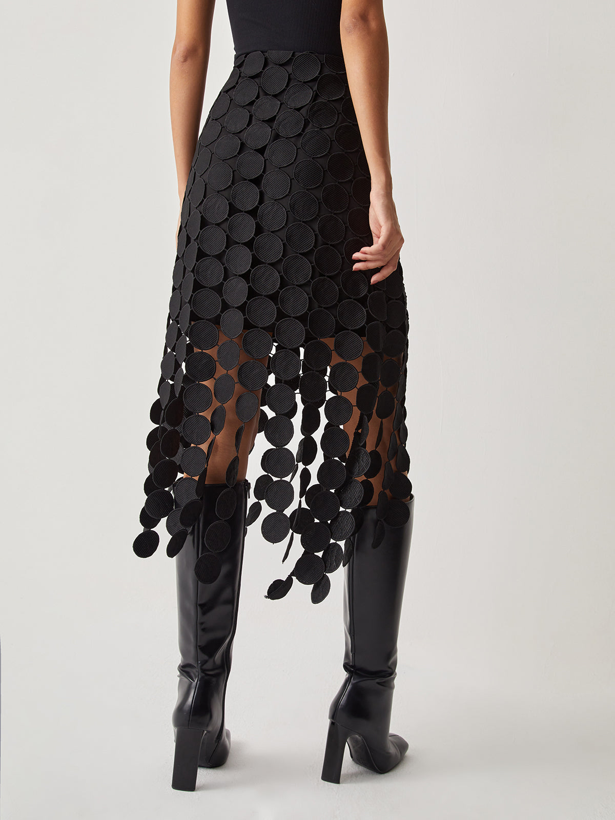 Black high-waist mesh midi skirt with circular disc overlay, front view