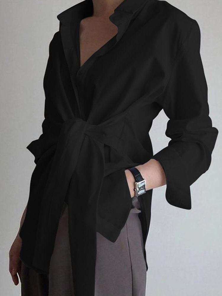 Black cotton poplin blouse with long sleeves, shirt collar, and tie-front waist
