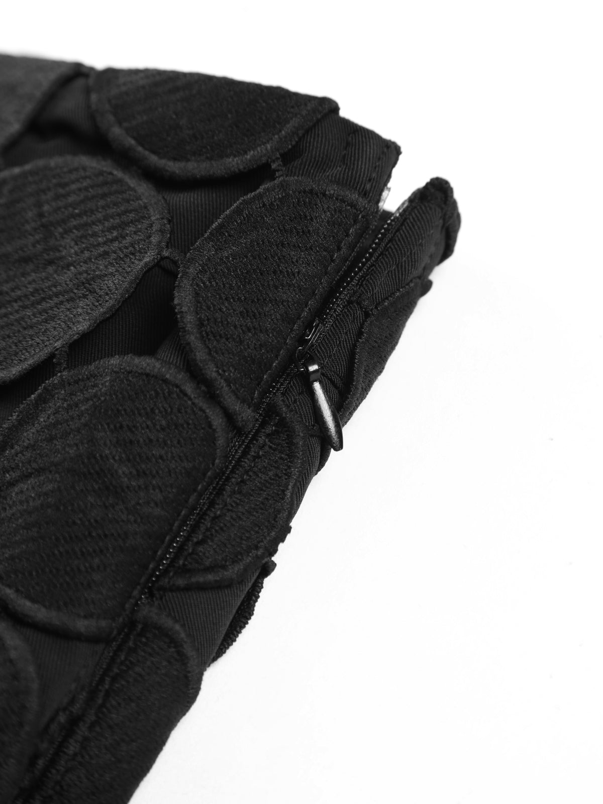 Black circular-disc mesh skirt detail with visible zipper and waistband seam