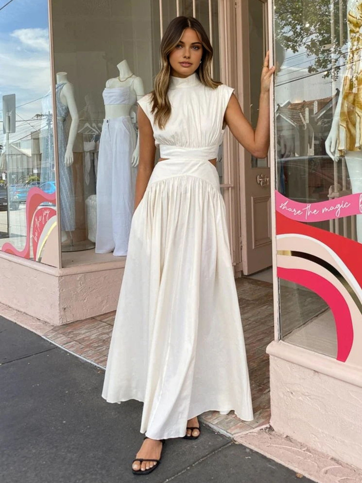 White mock-neck sleeveless maxi dress with ruched waist and gathered full skirt