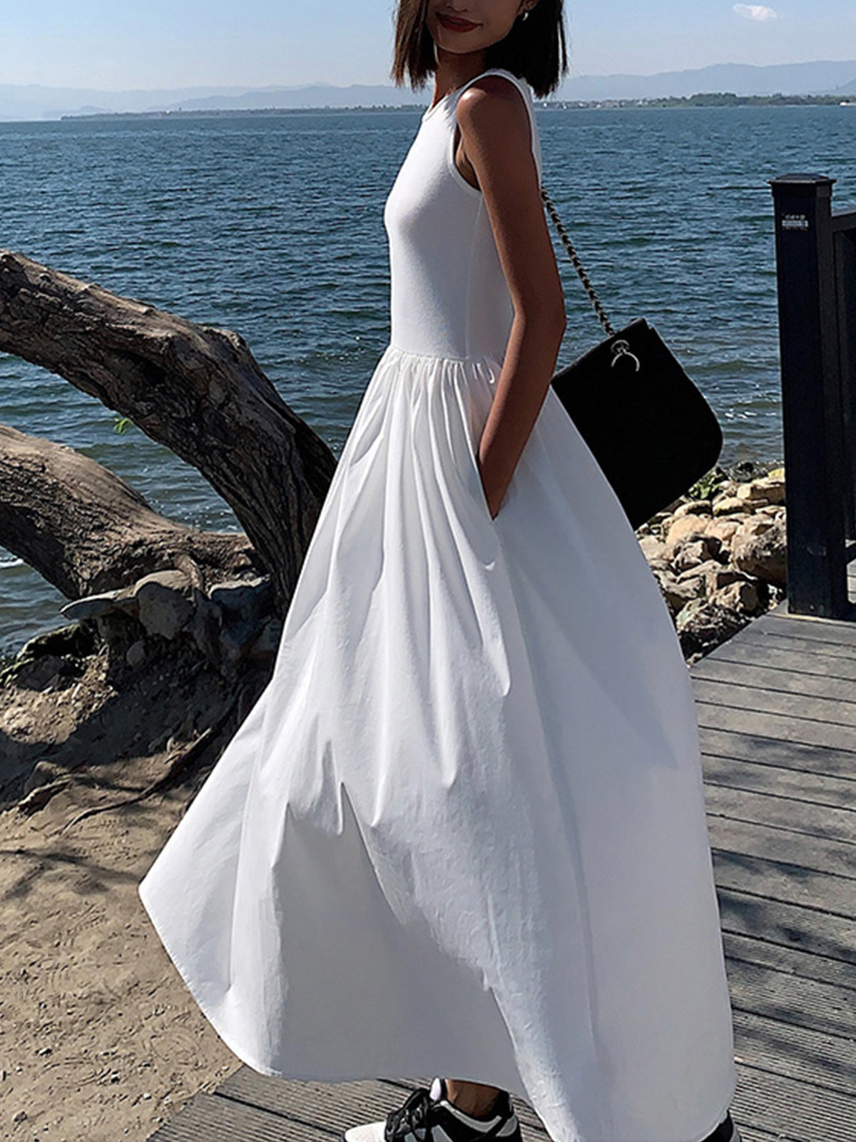 White cotton sleeveless midi dress with ribbed bodice and full gathered skirt