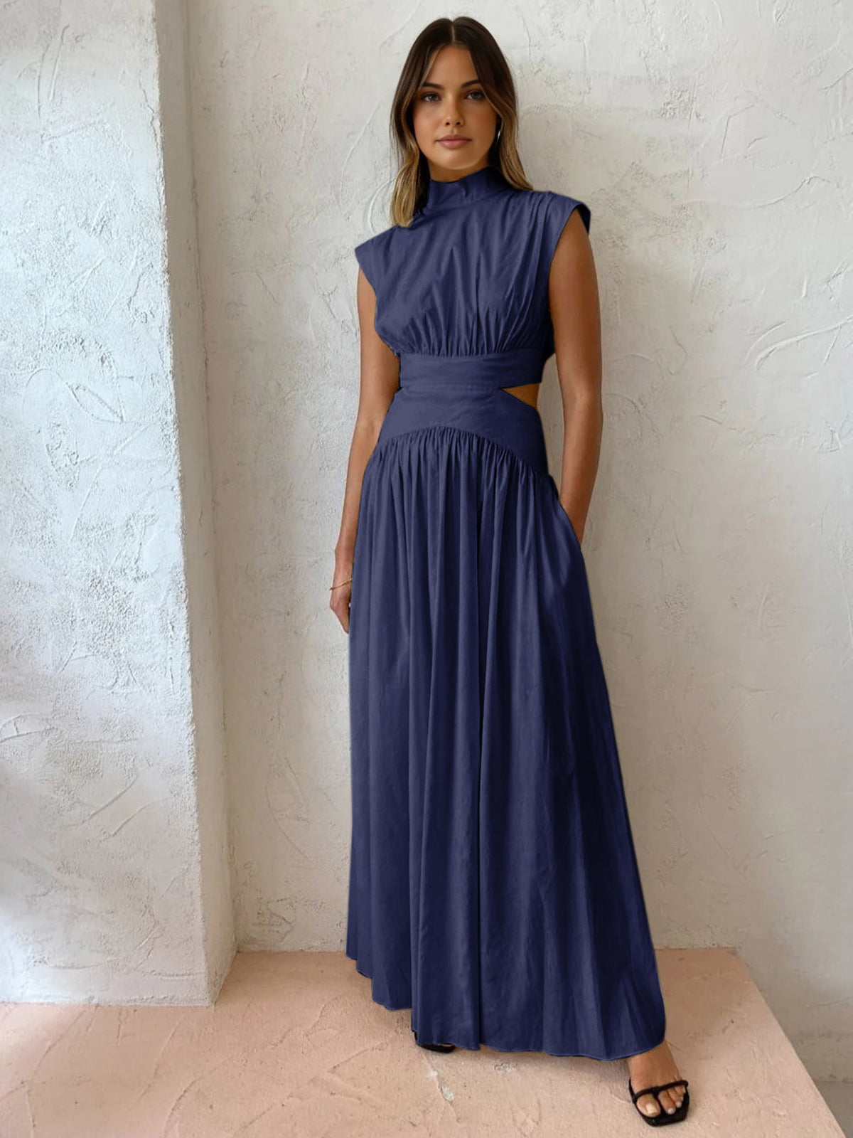 Navy sleeveless mock-neck maxi dress with ruched bodice and full gathered skirt