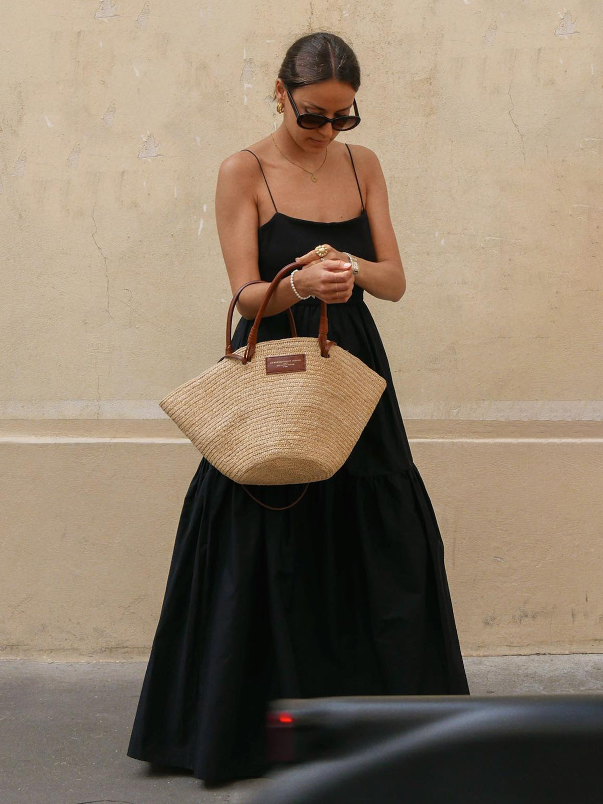 Black backless long dress with spaghetti straps, tiered skirt, and square neckline