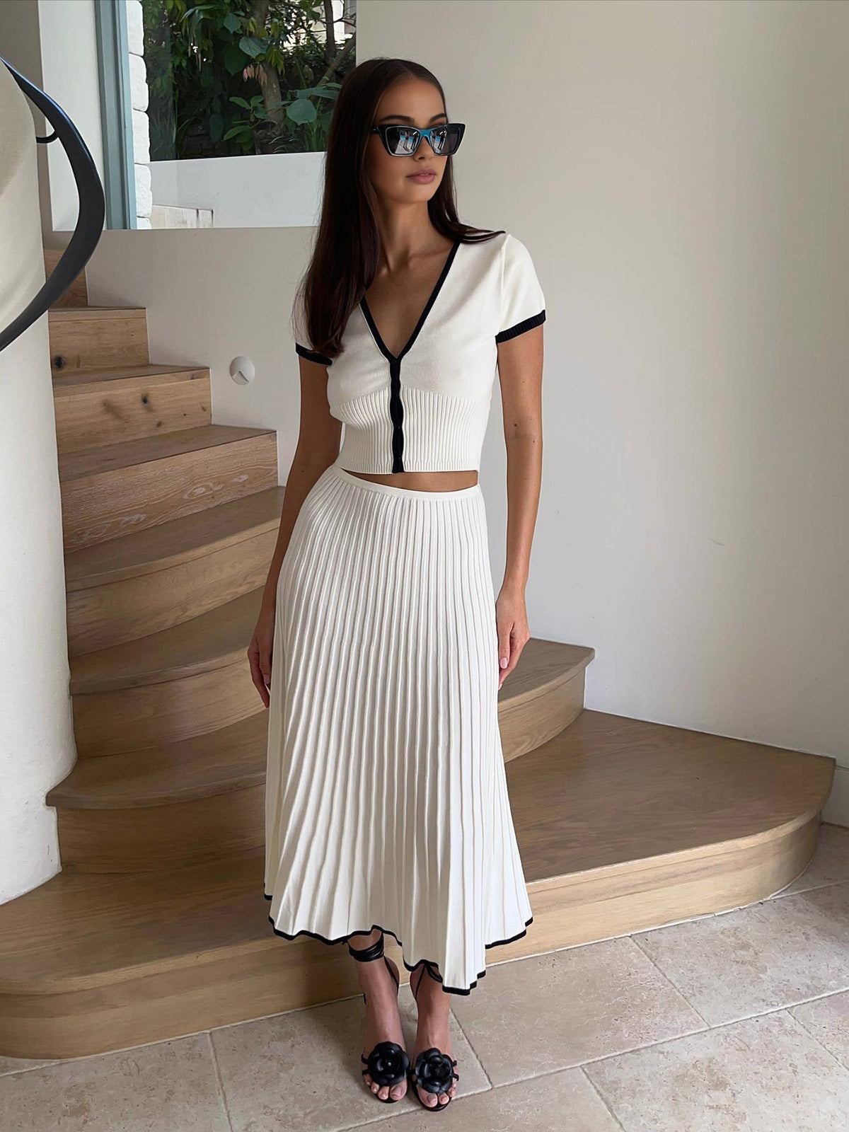 White pleated knit midi skirt with high waist and vertical pleat texture