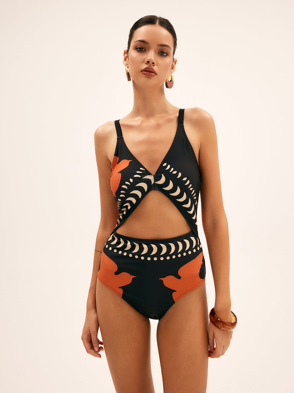 Women's one-piece swimsuit front, black with V neckline, cut-out midriff, orange bird print