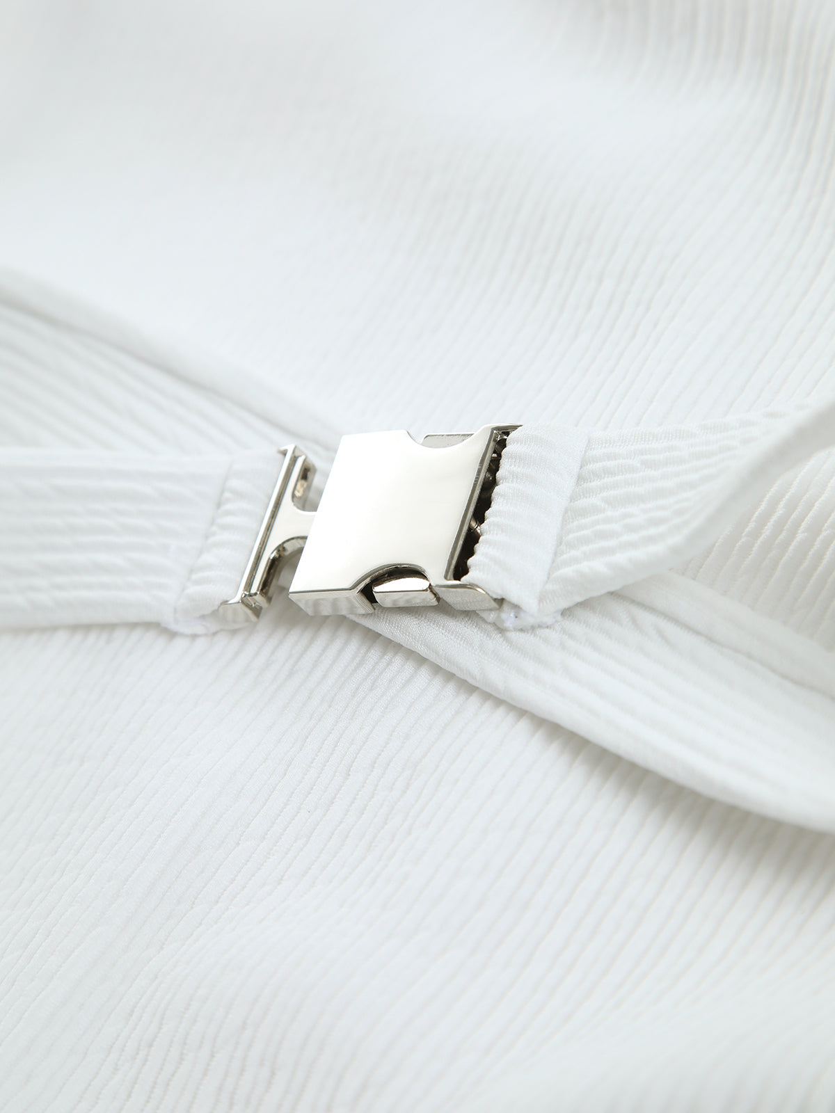 Close-up view of white ribbed stretch fabric on a one-piece swimsuit