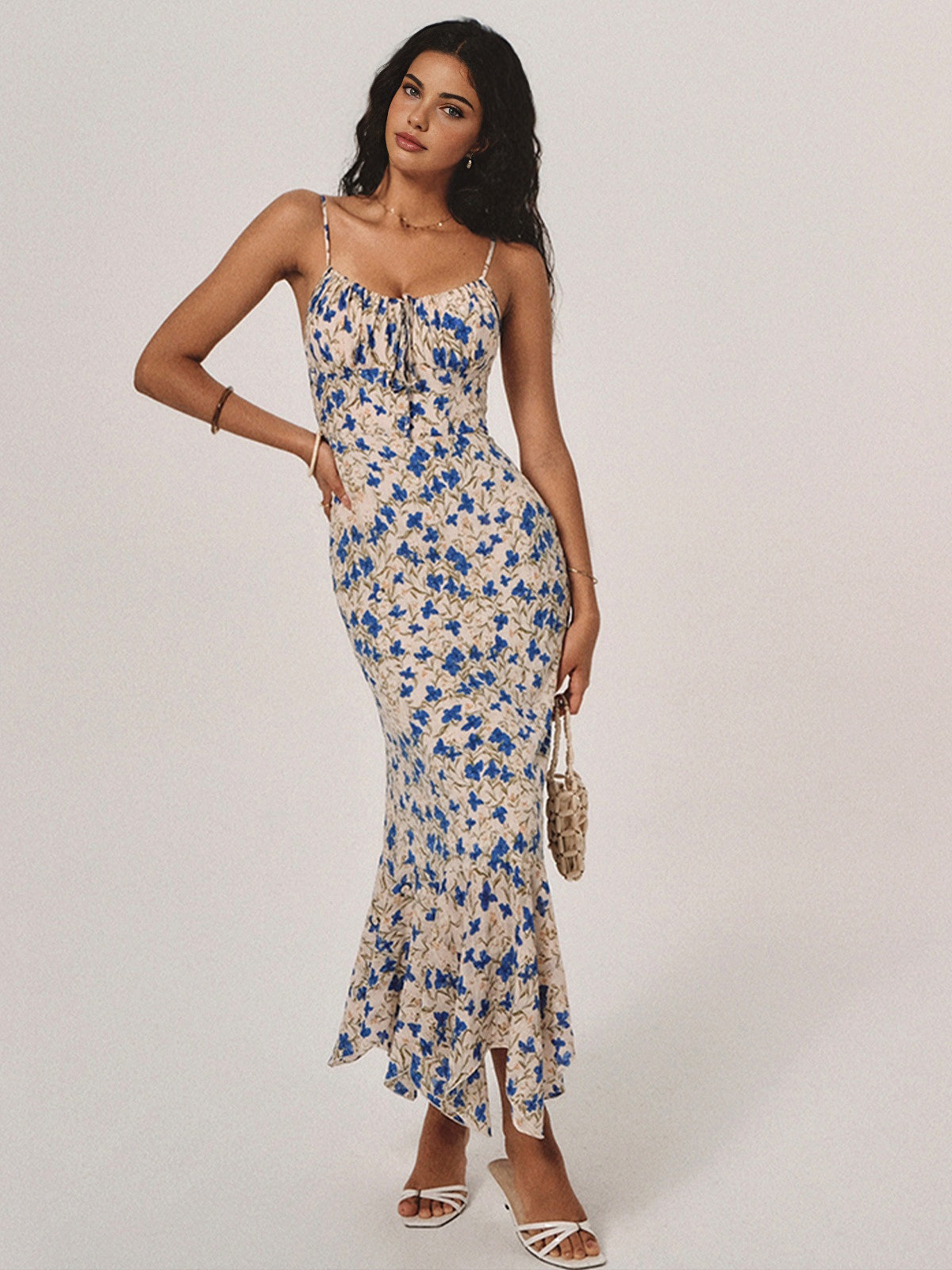 Blue floral maxi dress with spaghetti straps, ruched bodice, and tapered skirt