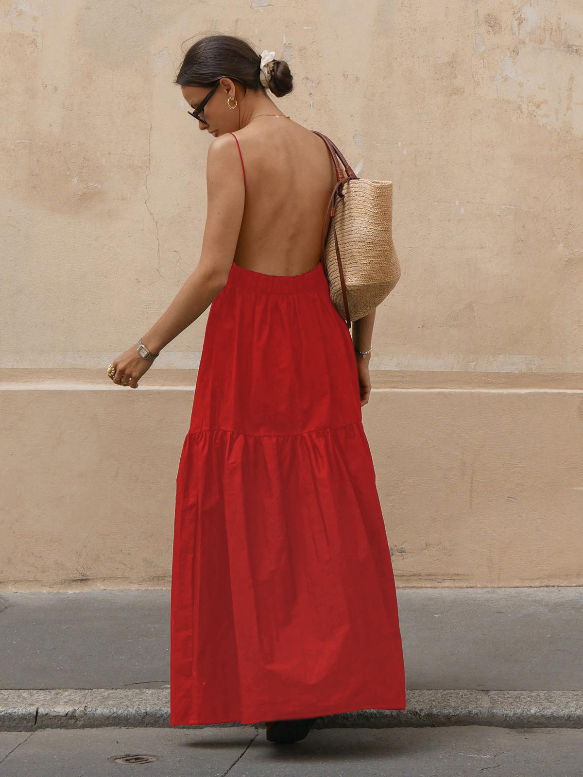 Red backless long dress with open back, spaghetti straps, and tiered ruffle hem