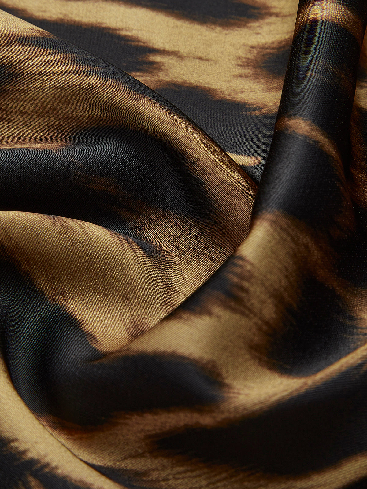 Leopard print viscose fabric with dark spots and glossy black-beige pattern