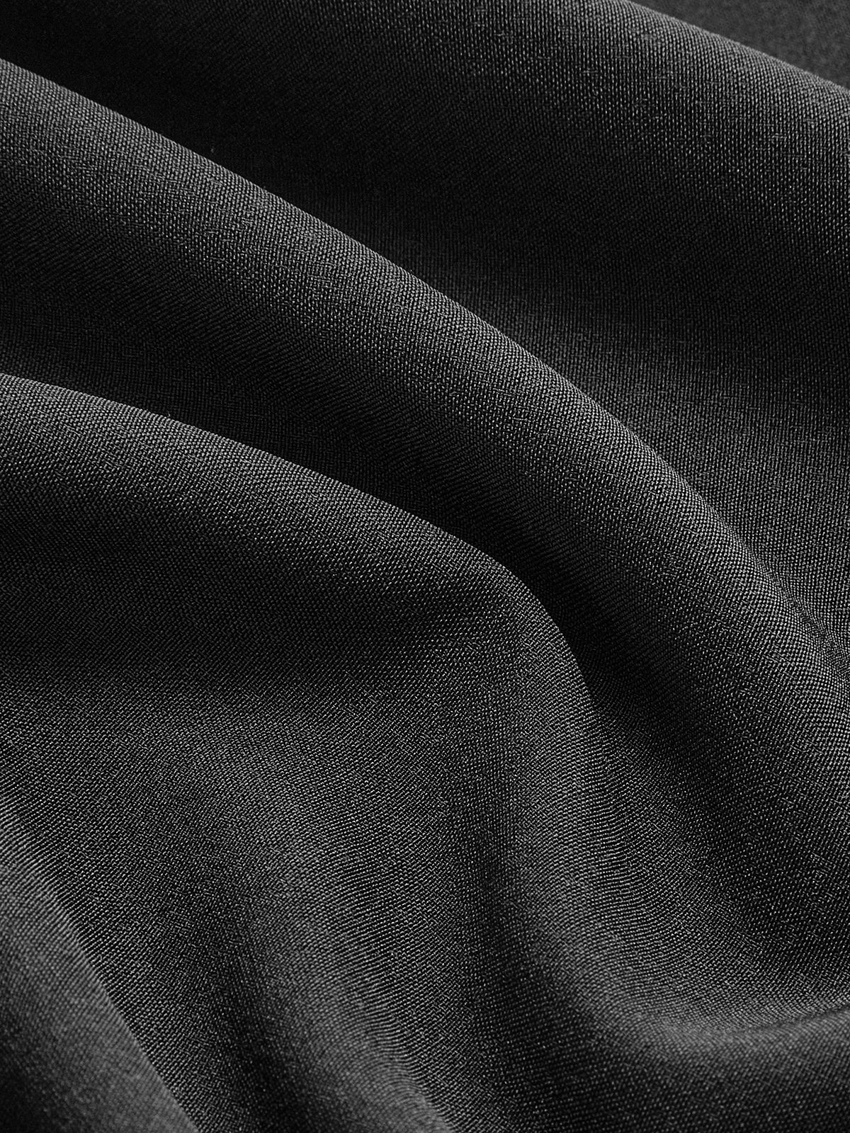 Black woven fabric drape detail with smooth sheen