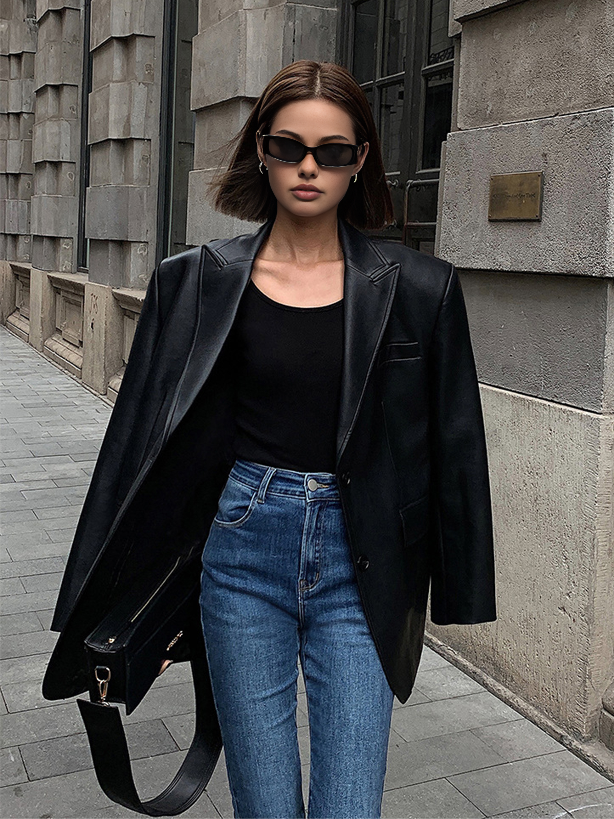 Black faux leather blazer with notched lapels and single-button front