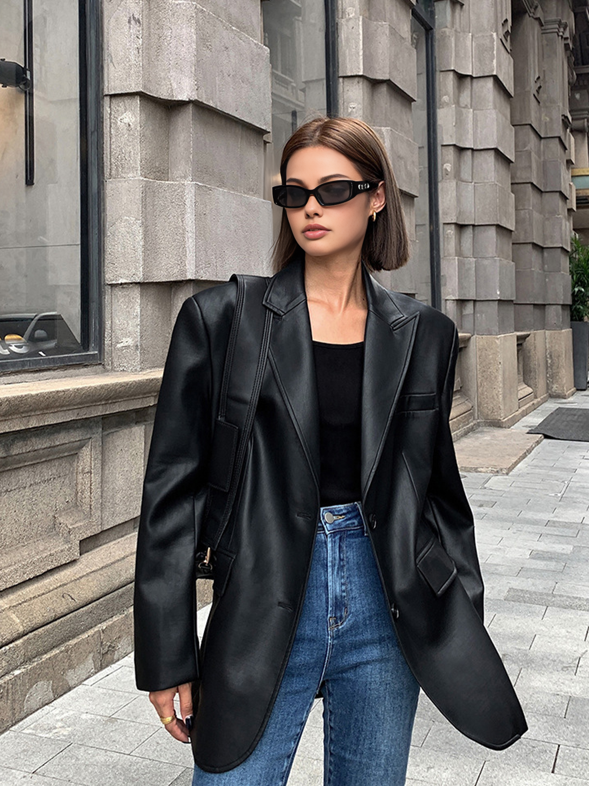 Black faux leather oversized blazer with flap pockets and notched lapels