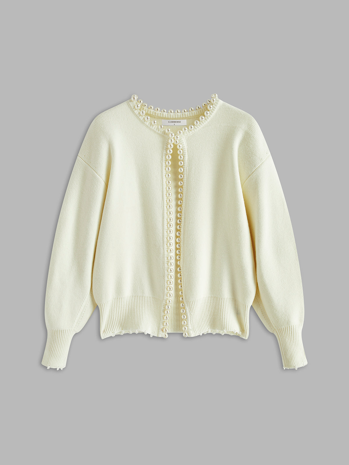 Cream open-front cardigan with long pearl trim placket and ribbed cuffs