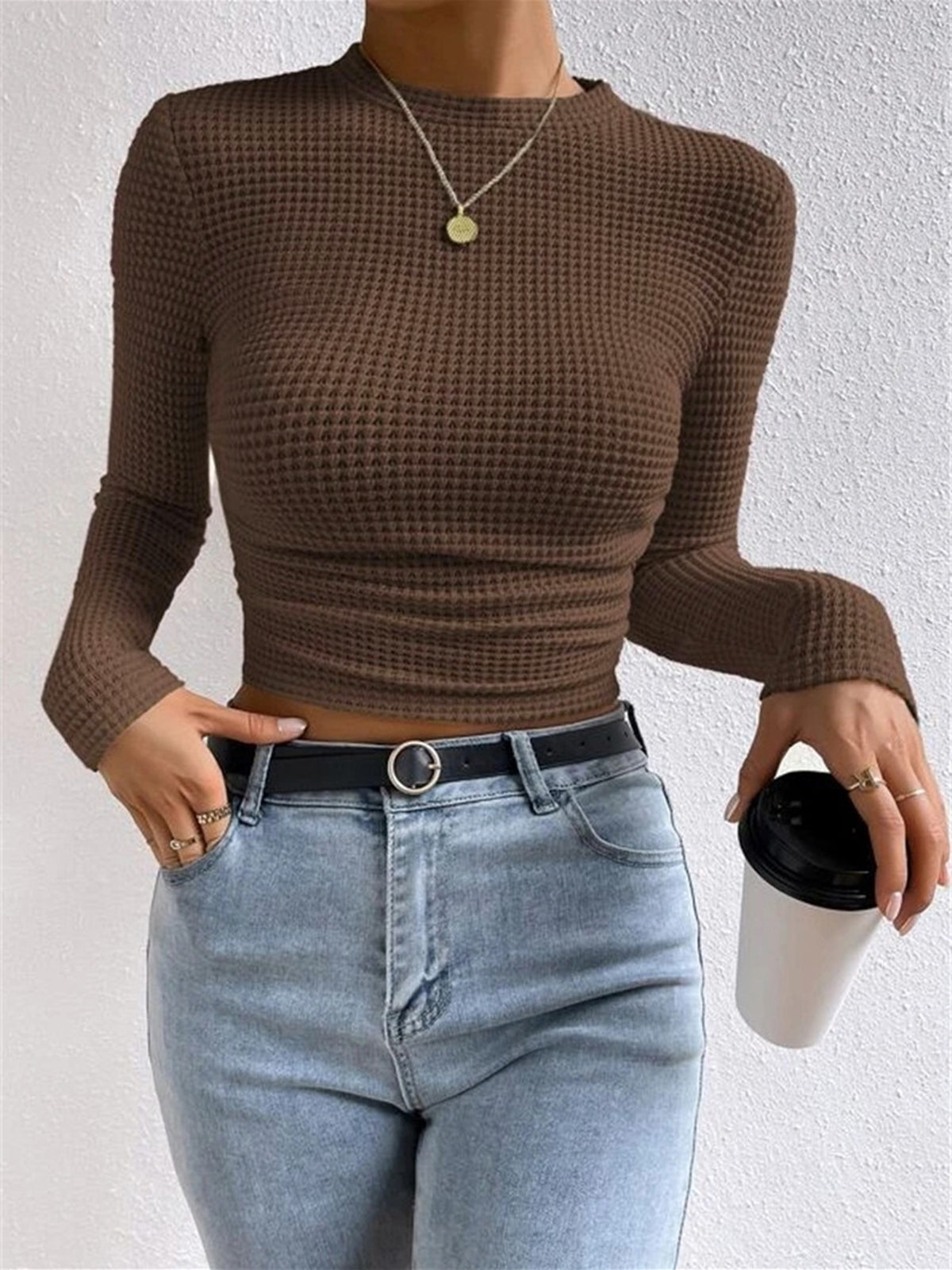 Light brown waffle knit long-sleeve crop top with round neck and ruched hem