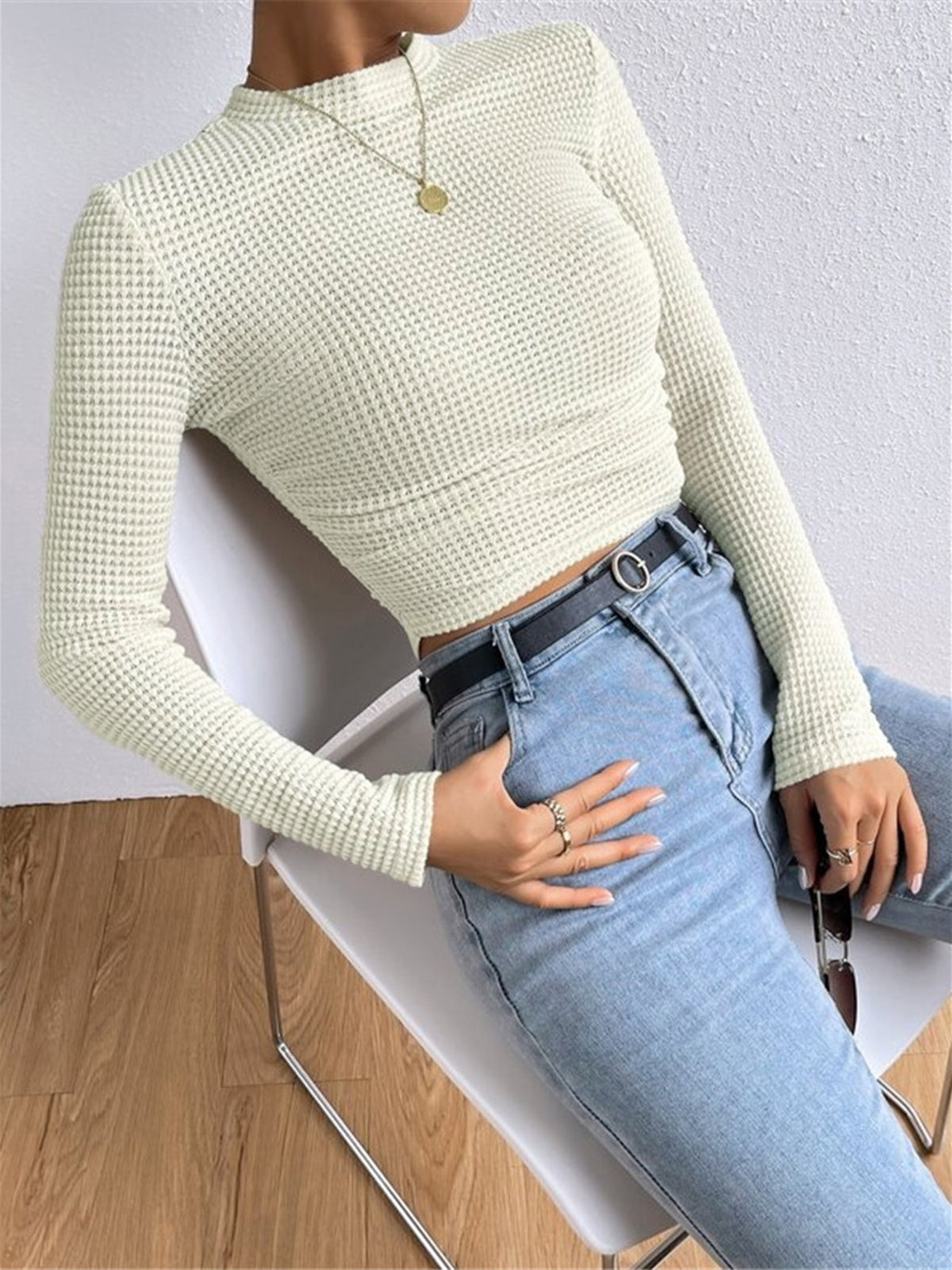 Light cream waffle-knit long-sleeve slim crop top, side ruched detail and fitted sleeves.