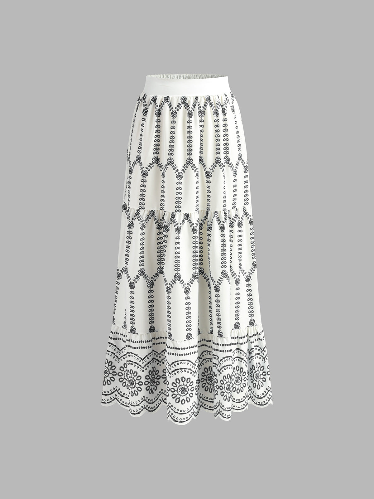 White maxi skirt with black embroidered pattern and scalloped lace hem