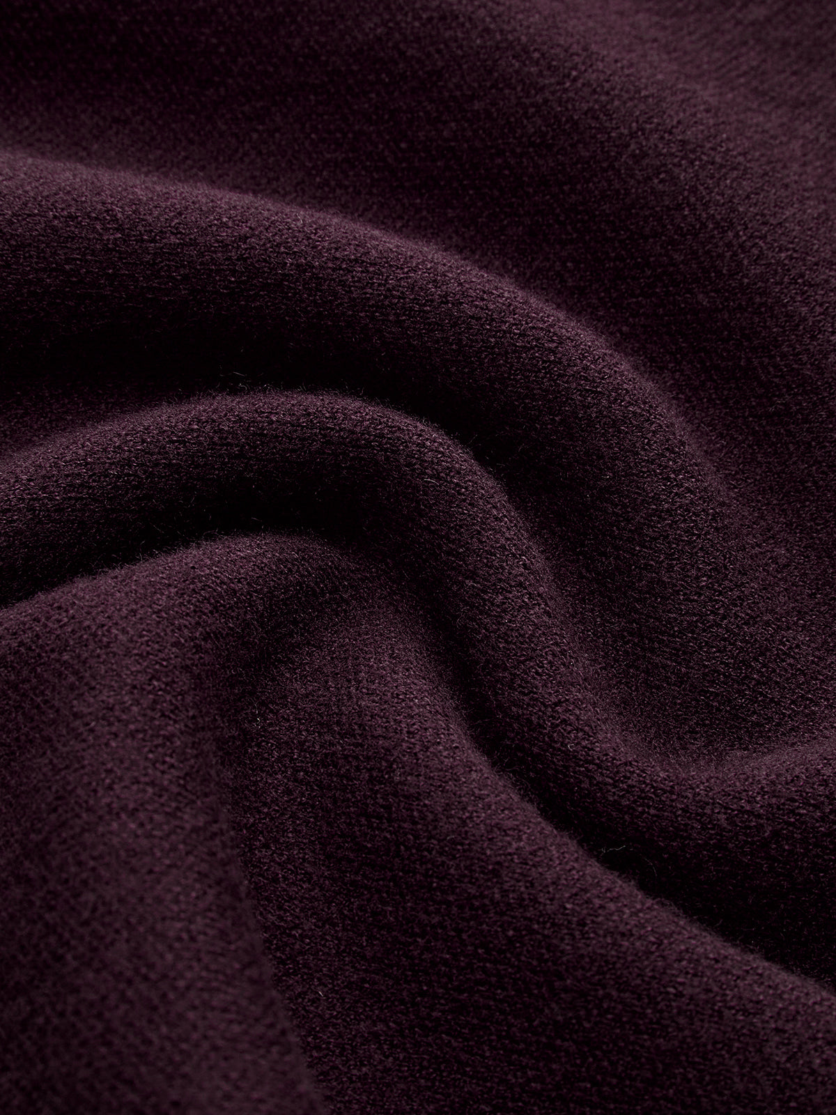 Burgundy viscose knit fabric close-up with fine textured weave