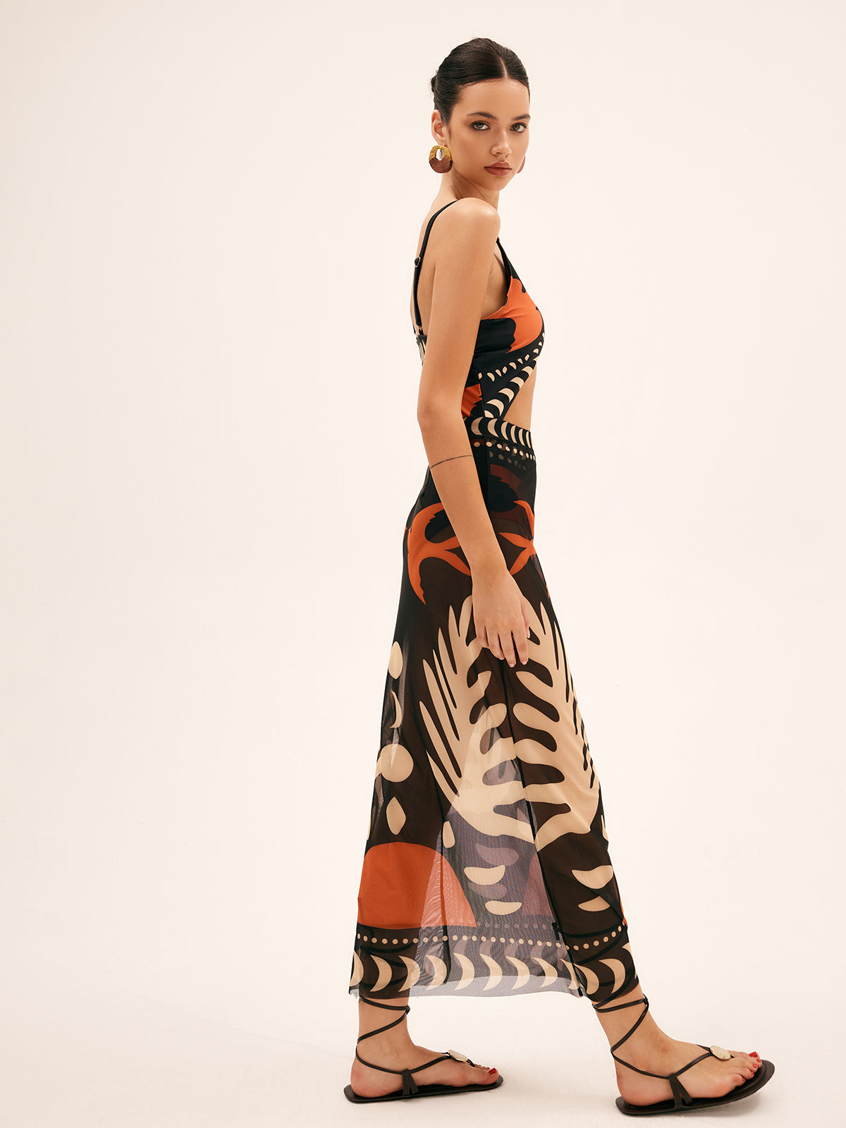 Sheer chiffon maxi skirt side view, black with orange and beige tropical abstract print