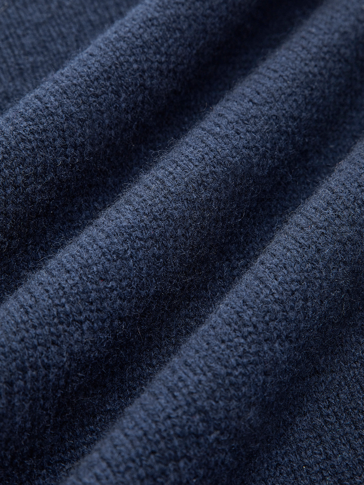 Dark navy knit fabric close-up with fine texture and ribbed weave