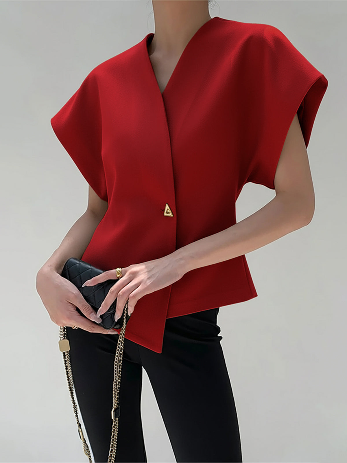 Red crepe blouse with V-neck, cap sleeves, and an asymmetric gold button detail