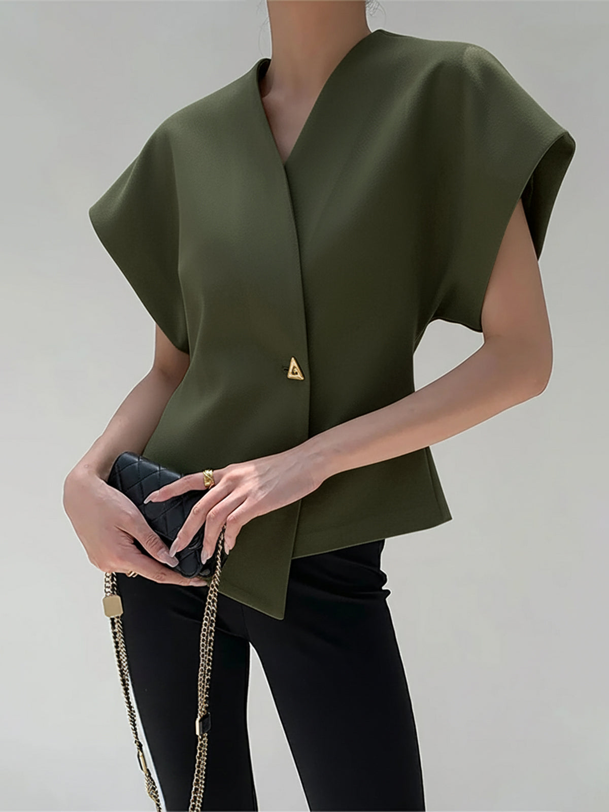 Olive green crepe blouse with V-neck, cap sleeves, and an asymmetric gold button detail