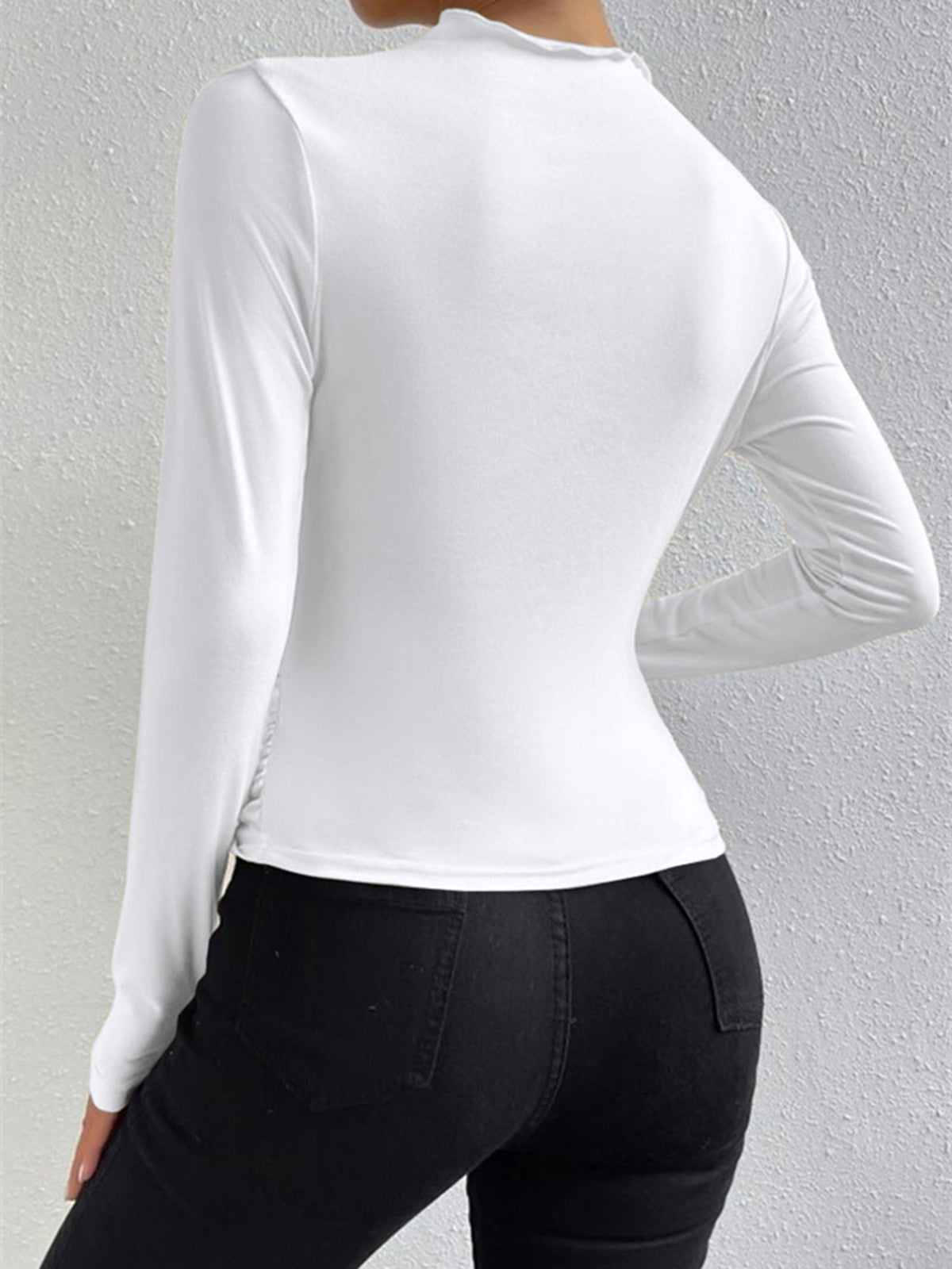 White long-sleeve fitted top with smooth back and slight draped shoulder