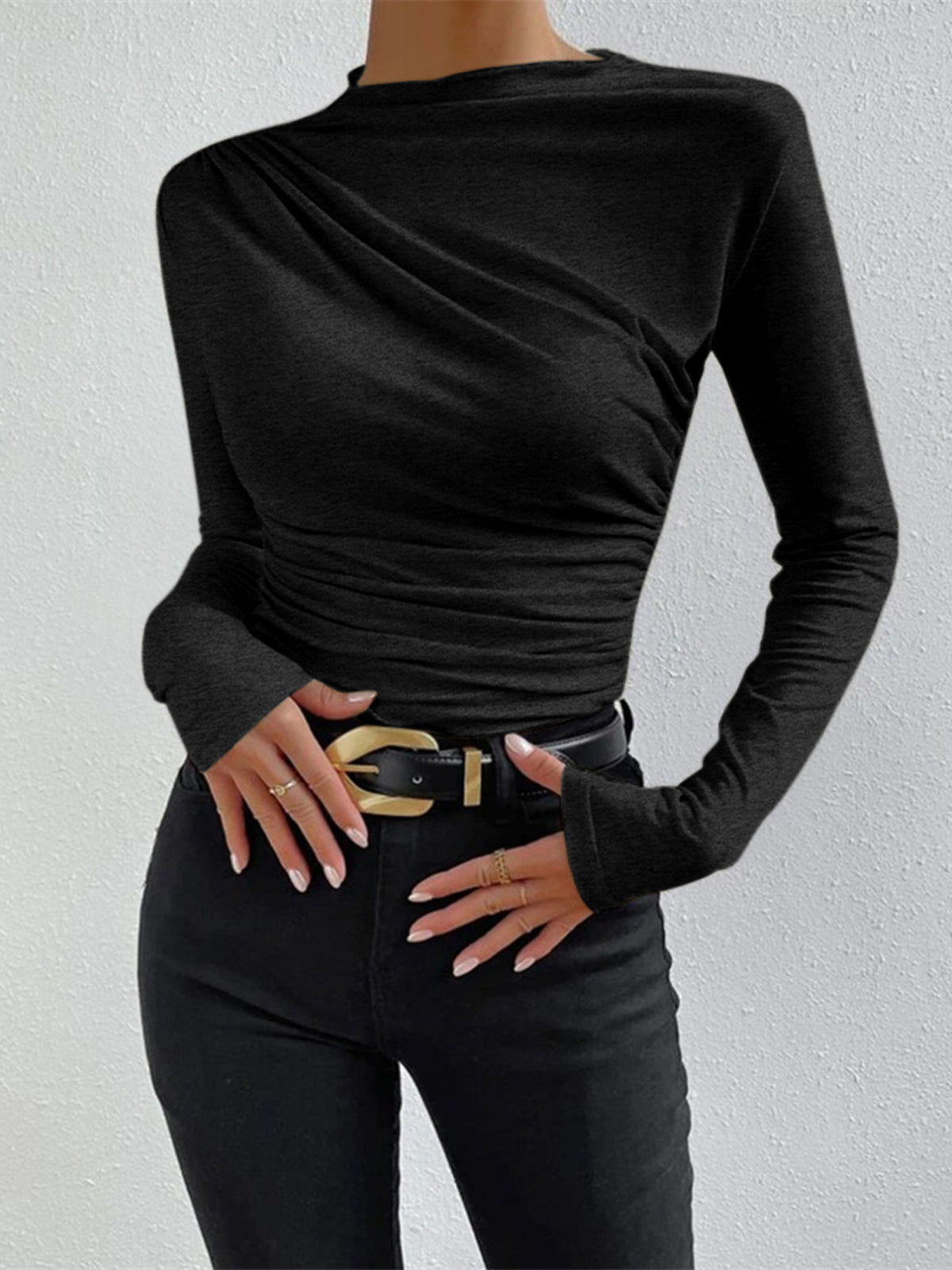 Black long-sleeve fitted top with draped asymmetric neckline and ruched side seams