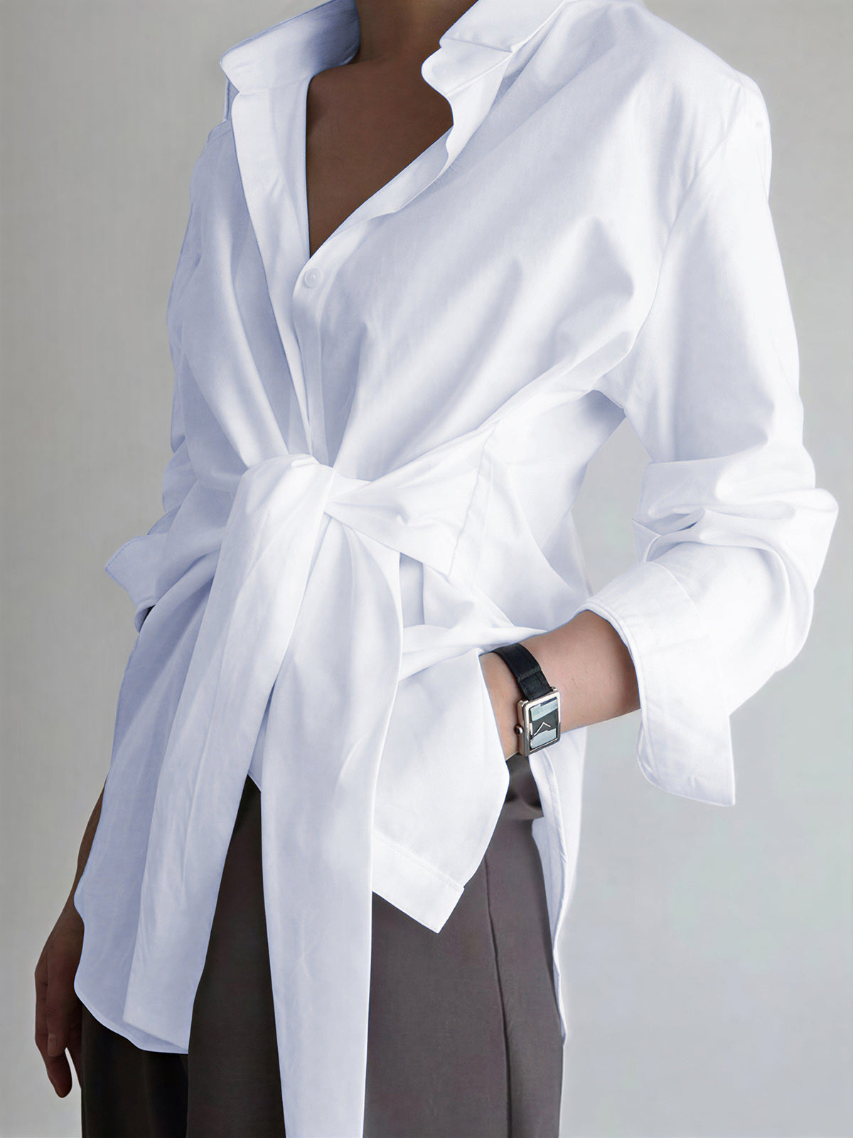 White cotton poplin blouse with long sleeves, shirt collar, and tie-front waist