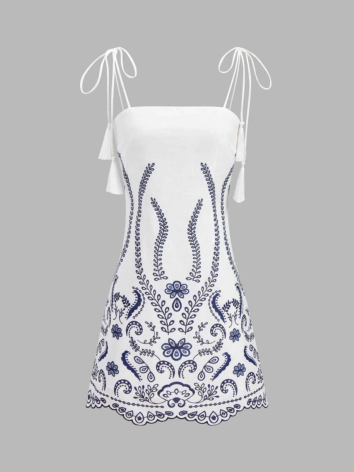 White cami mini dress with blue embroidered front, tassel-tie shoulder straps