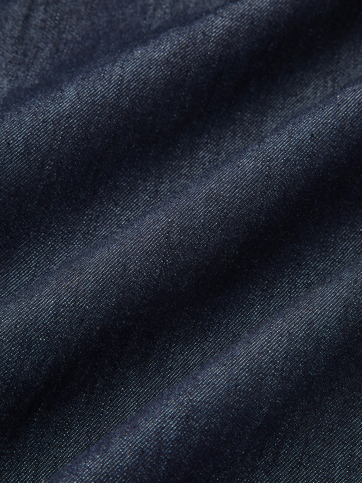Navy denim fabric close-up with fine texture and diagonal weave look