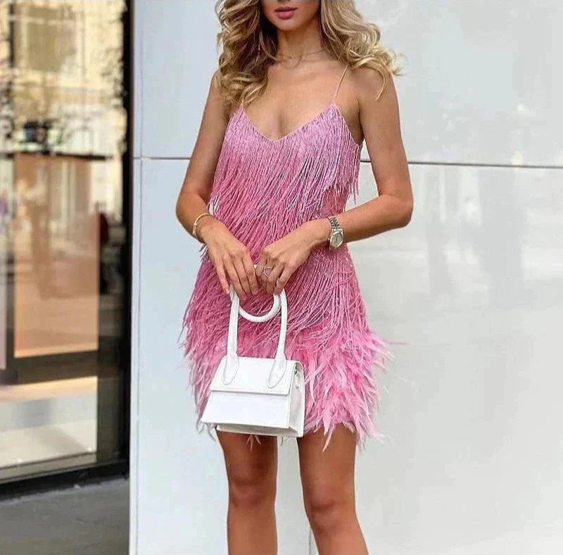 Pink v-neck mini dress with spaghetti straps, tassel fringe layers and feather hem