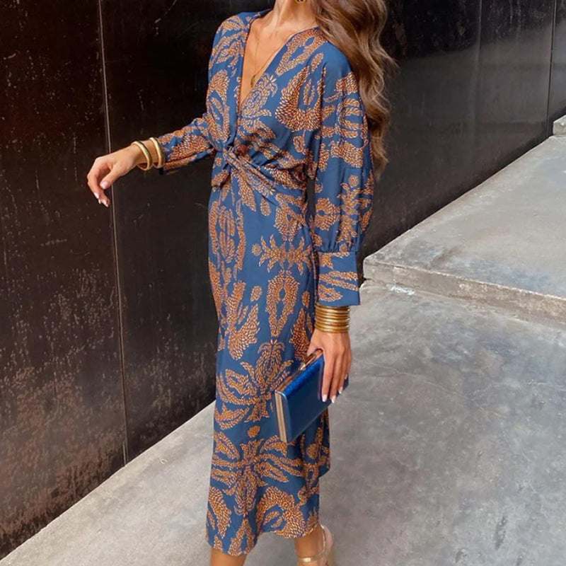 Blue midi dress with knot front waist, draped blouson sleeves, leaf motif pattern