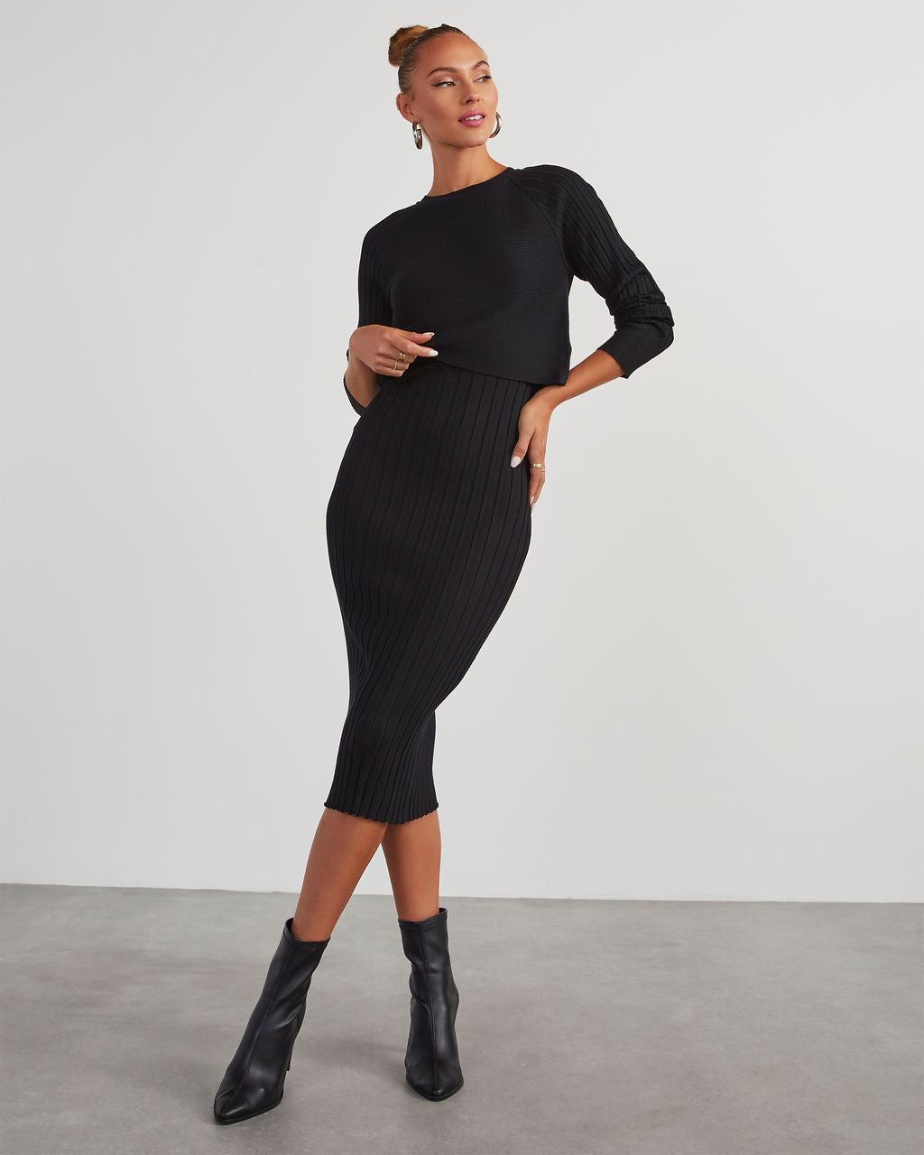 Black ribbed knit midi dress with long sleeves and fitted skirt