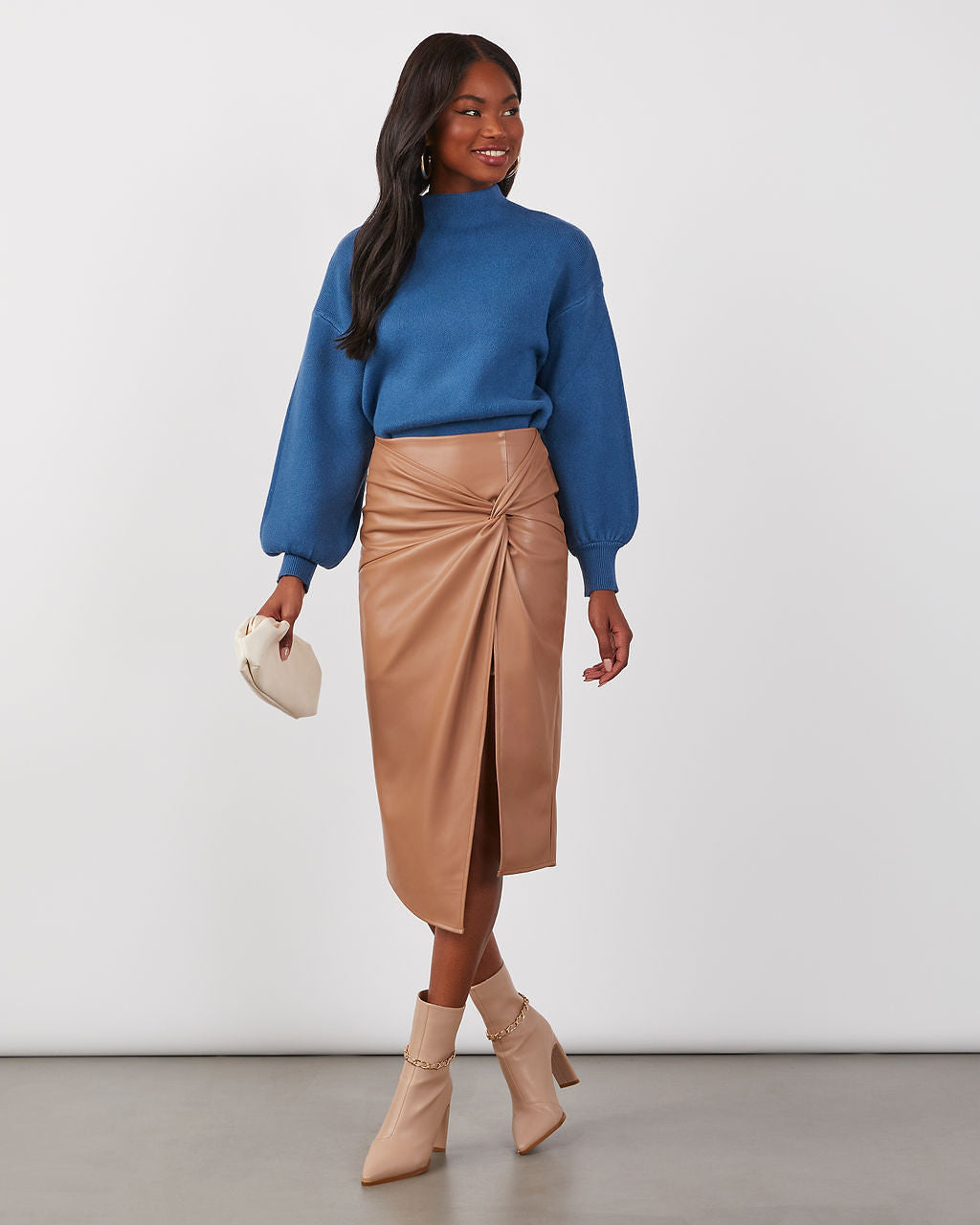 Blue mock neck sweater with long balloon-style sleeves and ribbed cuffs and hem.