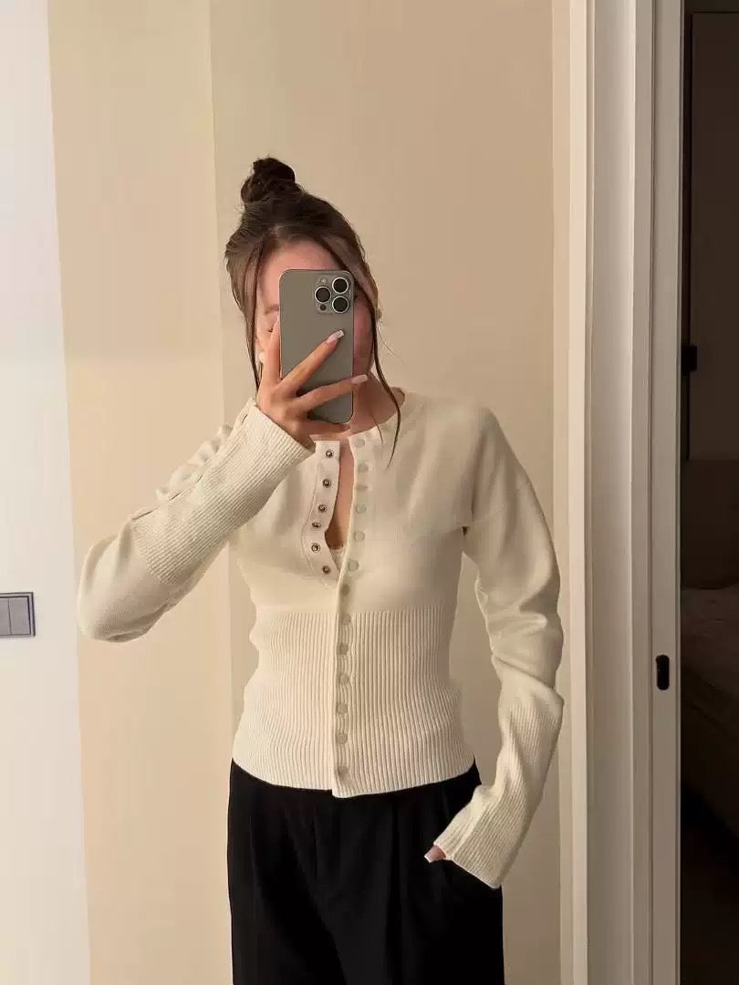 Cream ribbed knit cardigan with button front, long sleeves, cropped fitted