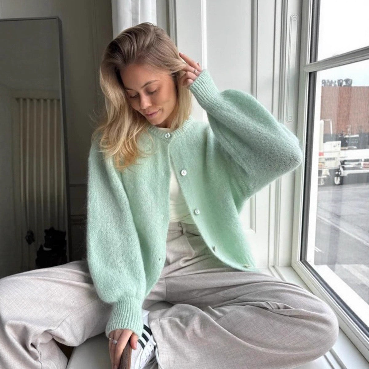 Mint green cropped button-front cardigan sweater with round neckline and long sleeves