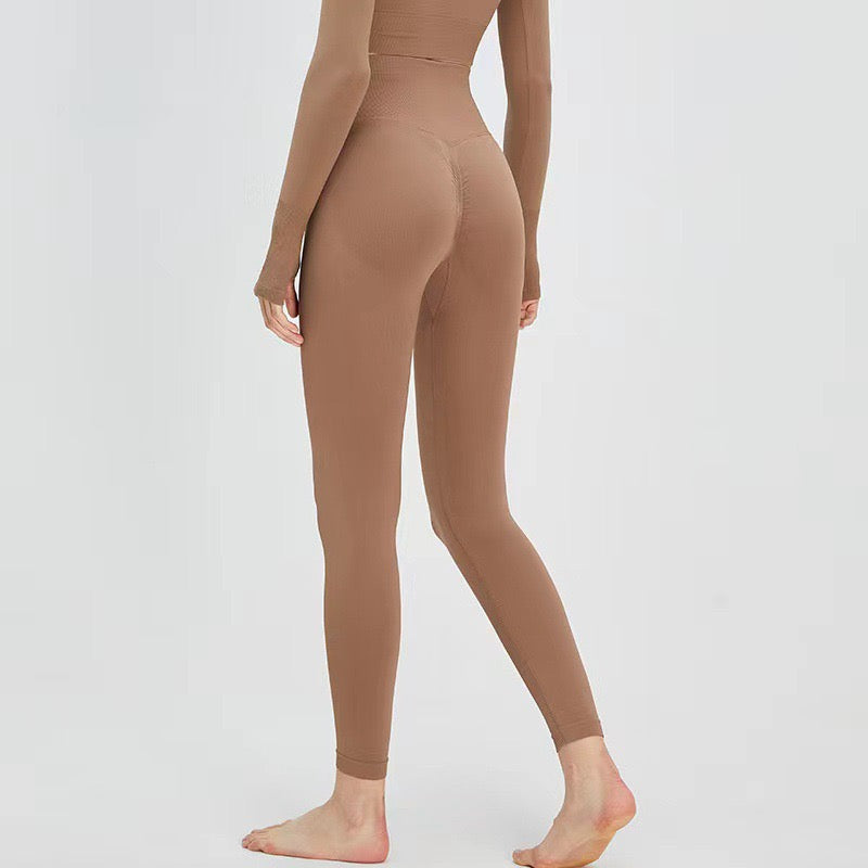 Taupe high-waisted full-length leggings with smooth contour seams, side view.