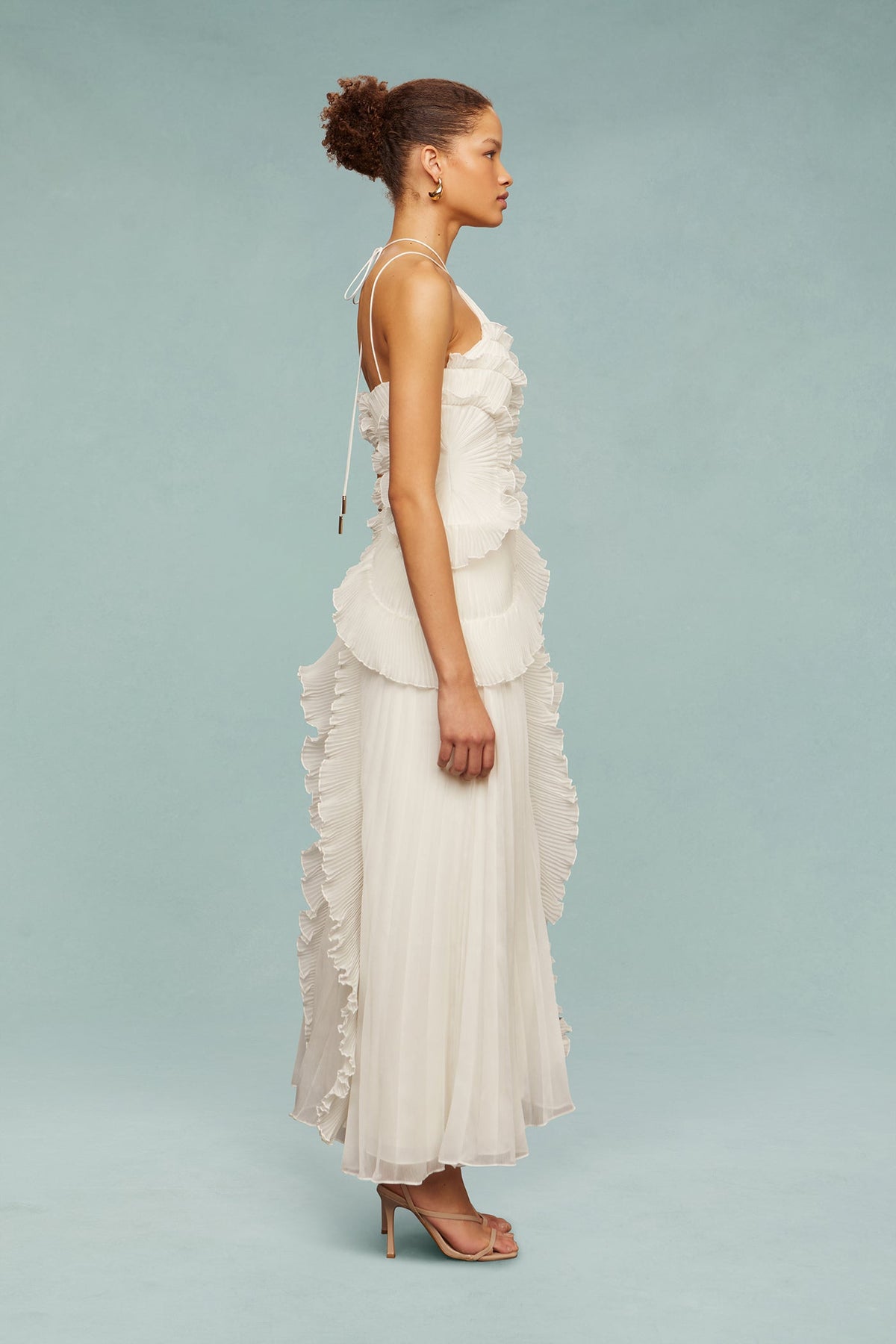 White chiffon maxi dress with ruffled shoulder detail and tiered ruffle skirt