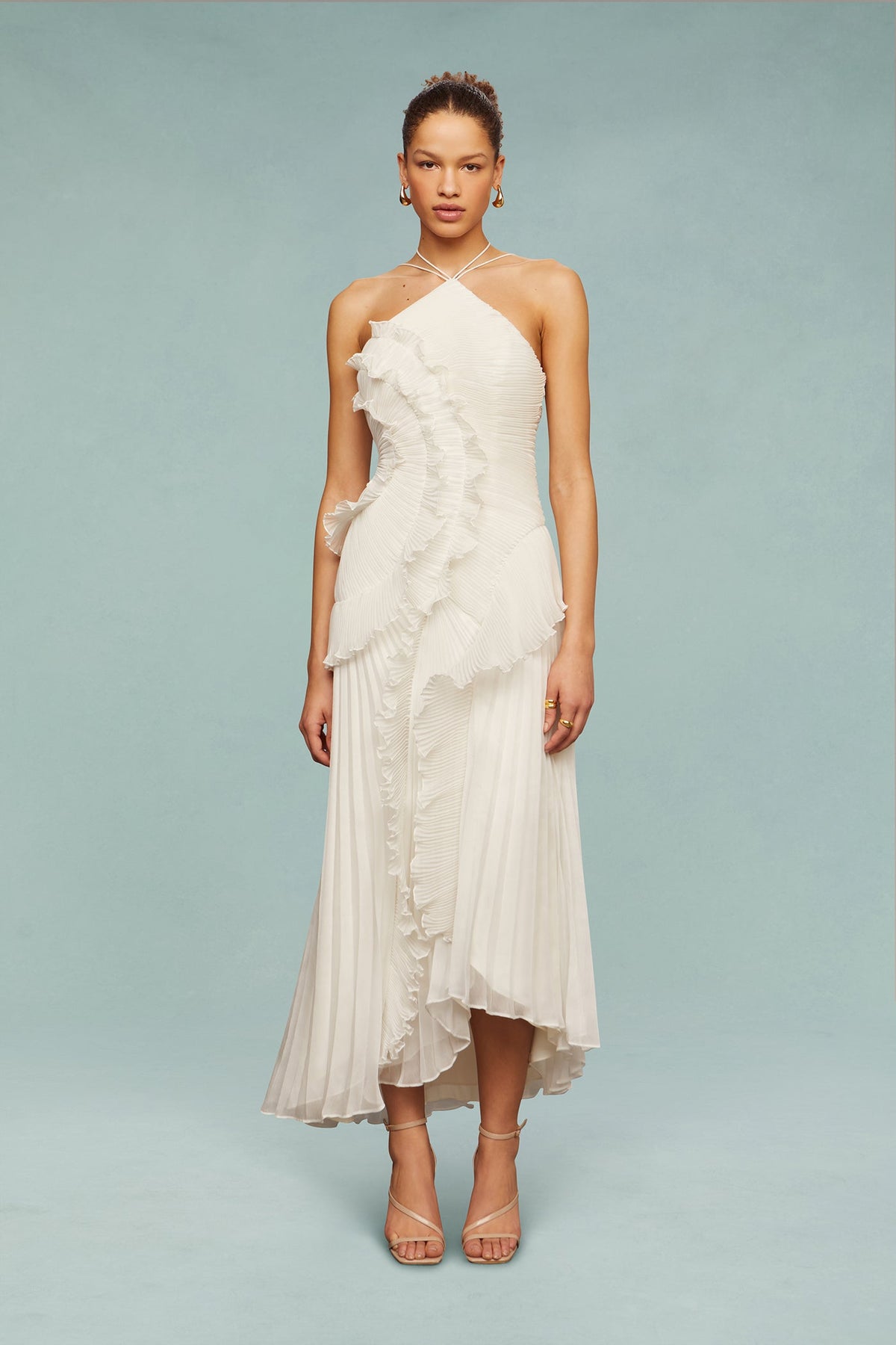 White chiffon halter dress with layered ruffle detail at bodice and asymmetrical hem