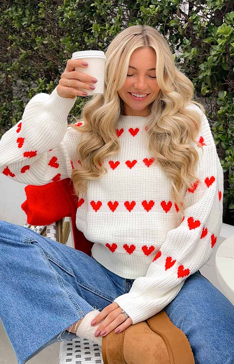 White heart-pattern knit jumper with red stripe hearts and ribbed crew neckline