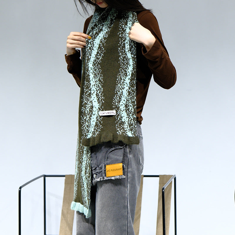Women's knitted scarf with dark green-and-cream speckle pattern and fringed ends